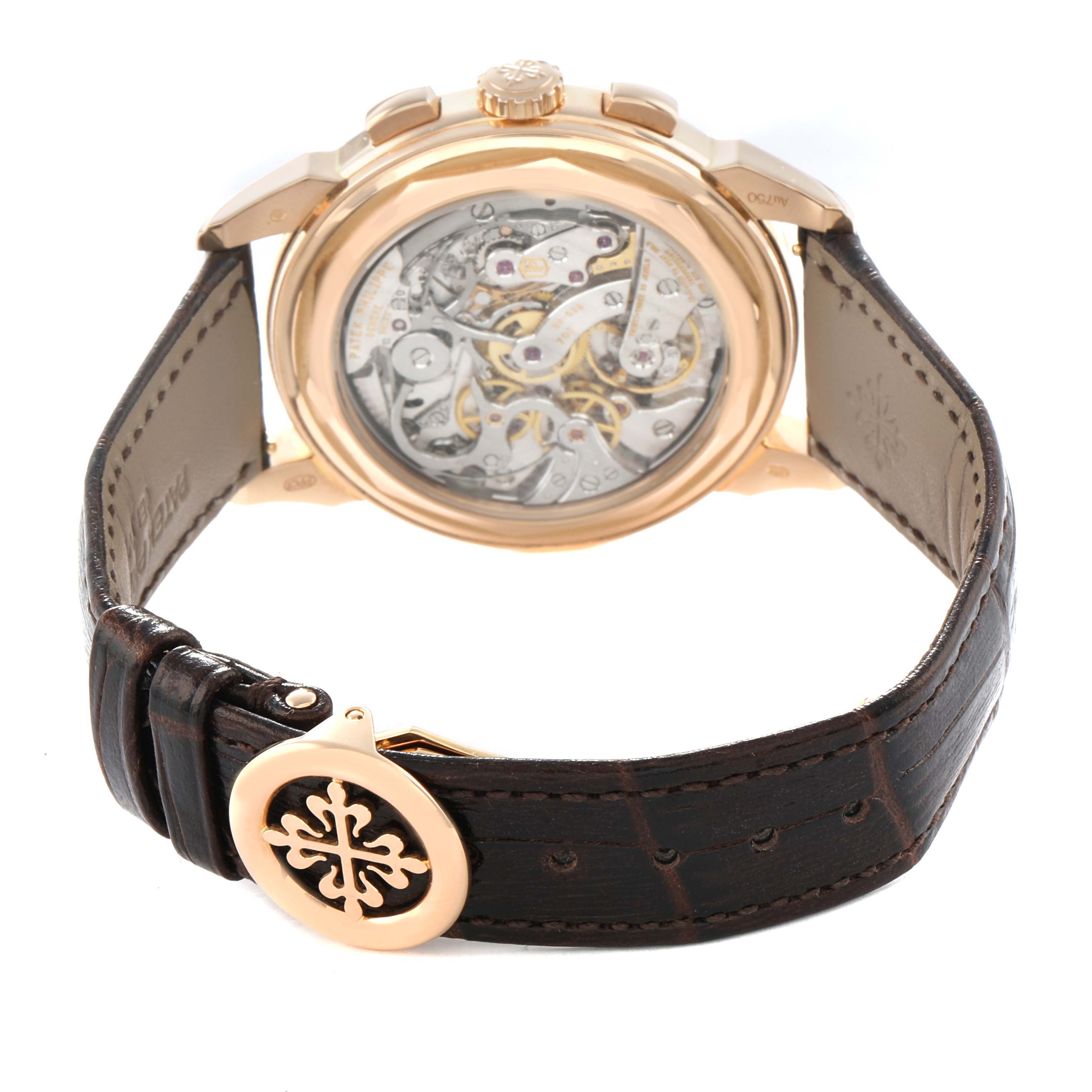 The image shows a Patek Philippe Complications 5270R-001 Men's Rose Gold Silver Dial watch from a rear angle, highlighting the transparent case back and movement.