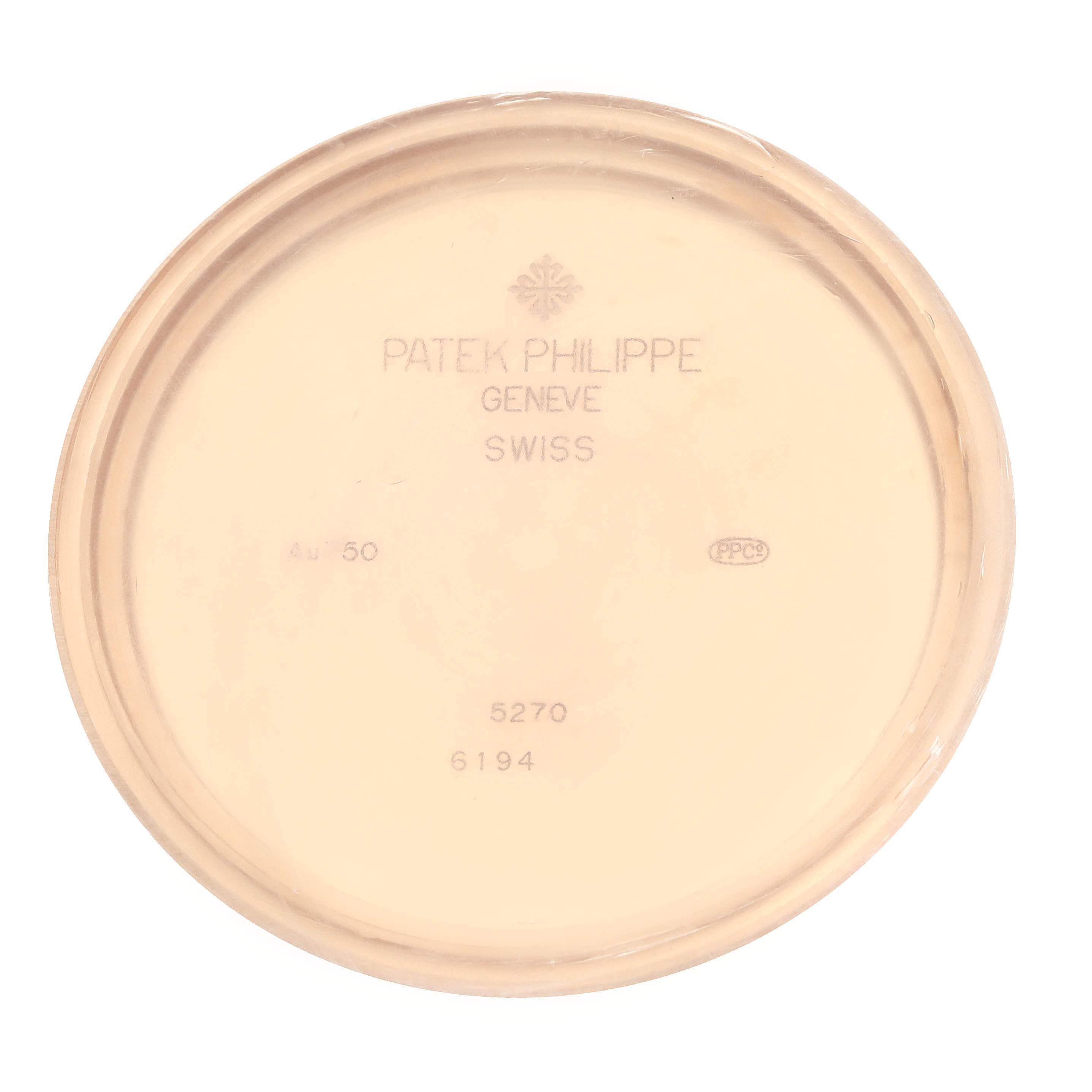 The image shows the inner case back of a Patek Philippe Complications 5270R-001 Men's Rose Gold Silver Dial model, displaying engravings and hallmarks.