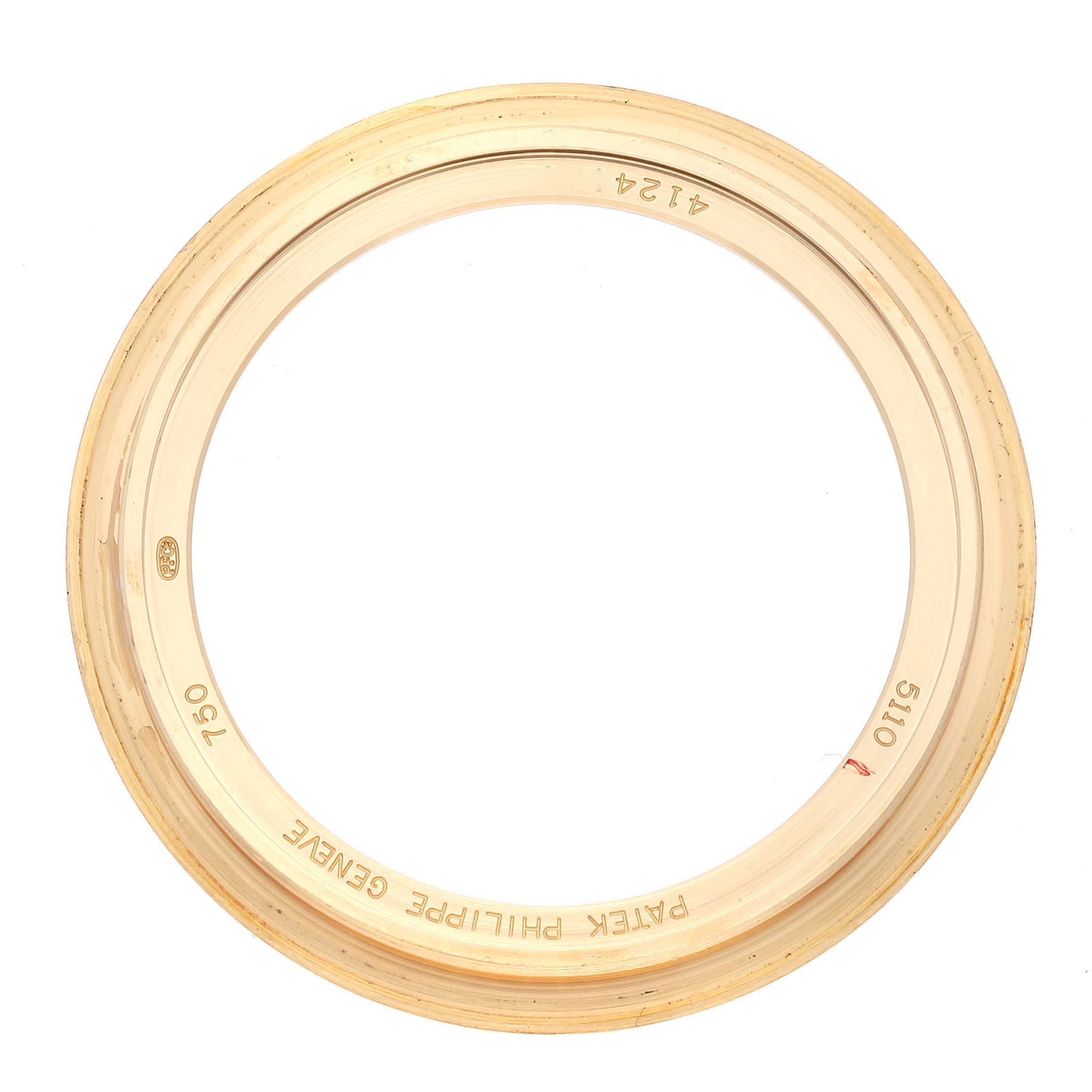 This image shows a golden bezel for a Patek Philippe Complications 5110 Men's Yellow Gold Silver Dial 5110 Men's Yellow Gold Silver Dial model, viewed from above.