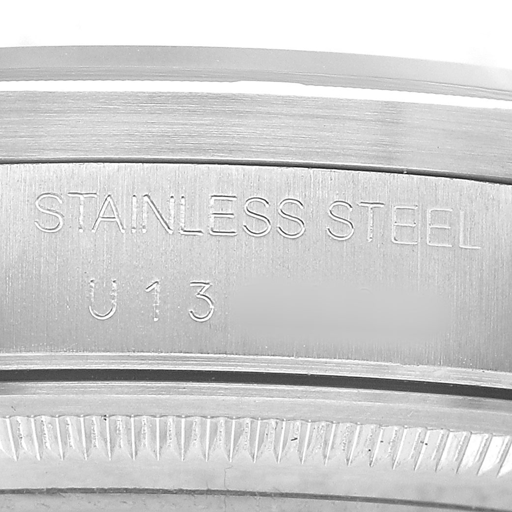 This image shows a close-up of the engraving on the stainless steel case of the Rolex Air-King 14010 Men's Stainless Steel Black Dial watch.
