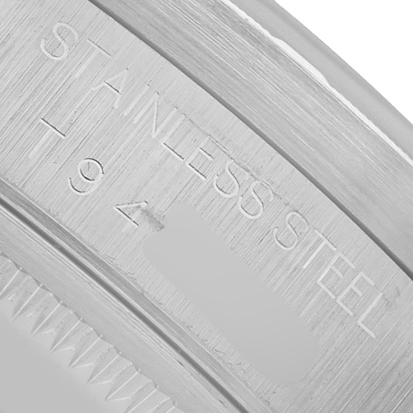 The image shows a close-up of the Rolex Air-King 14010 Men's Stainless Steel Blue Dial's stainless steel case with engraving details.