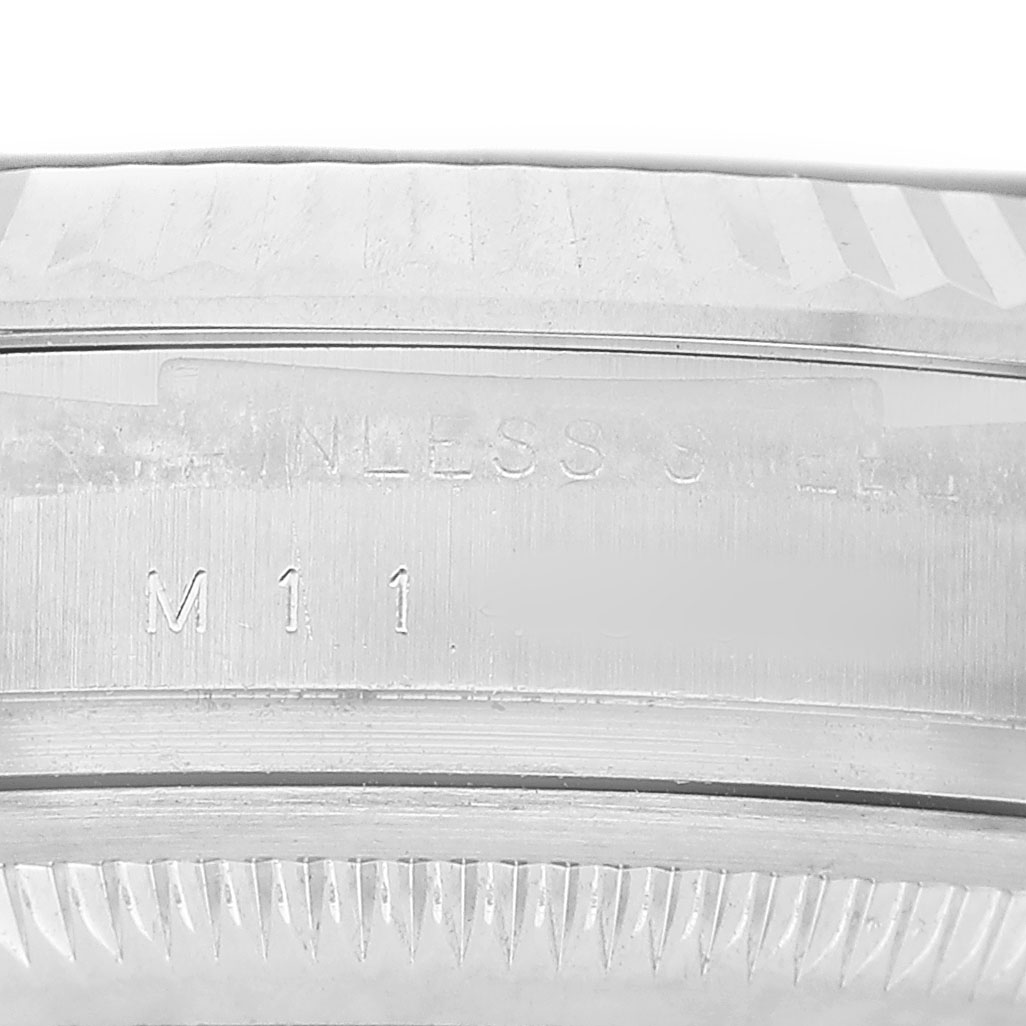 The image shows a close-up of the side of a Rolex Air-King 114234 Men's Stainless Steel Blue Dial, focusing on the engraved stainless steel case and part of the bezel.