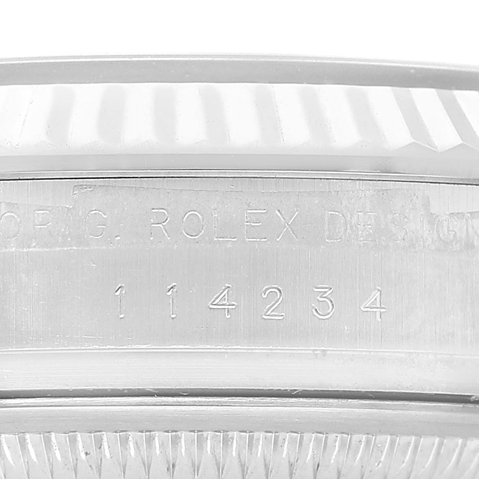 The image shows a close-up of the side engraving on a Rolex Air-King 114234 Men's Stainless Steel Blue Dial, displaying the model number and "ORIG. ROLEX DESIGN."