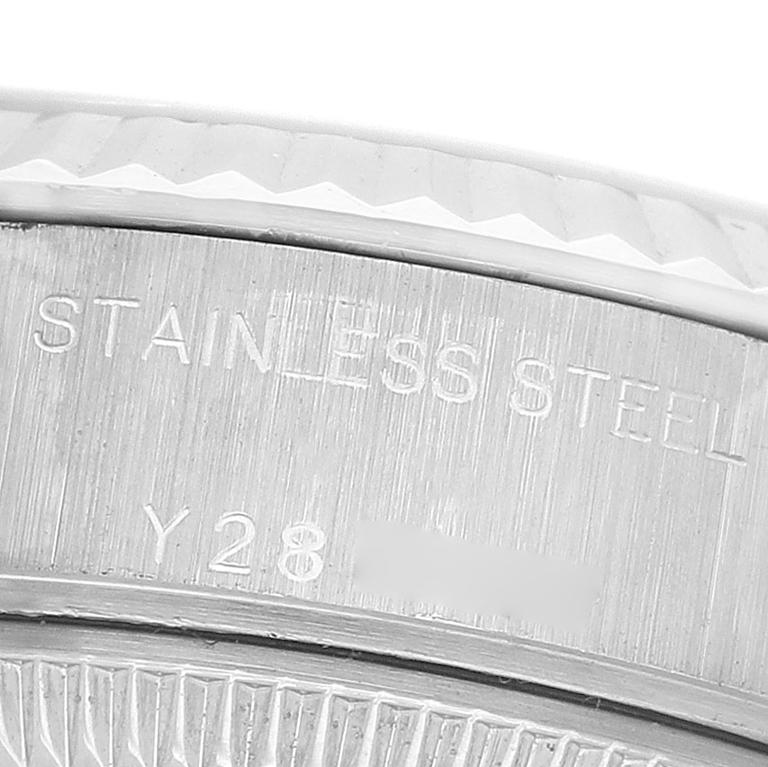 The image shows a close-up of the case side of a Rolex Datejust 79174 Women's Stainless Steel White Dial, featuring "STAINLESS STEEL" engraving.
