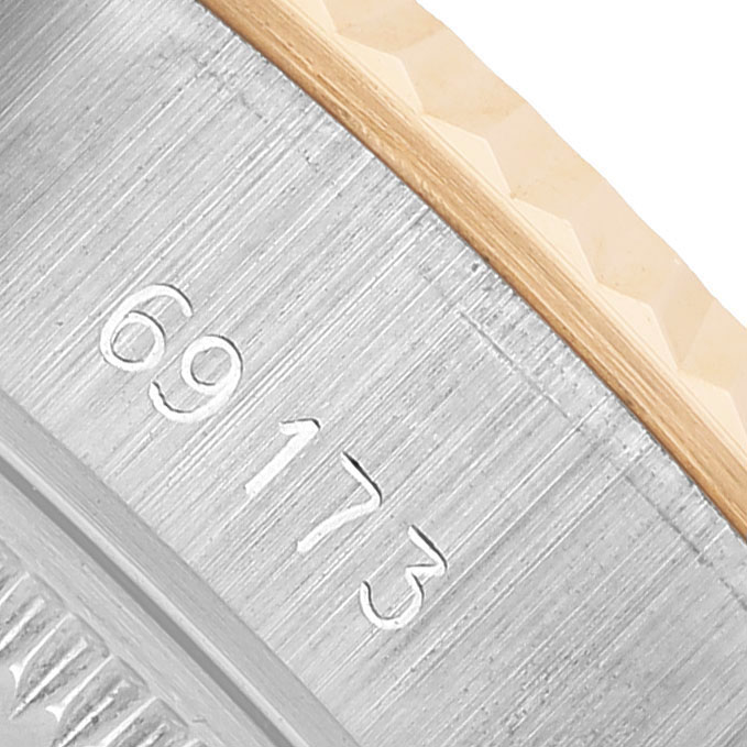 The image shows a close-up of the side case and bezel edge of a Rolex Datejust 69173 Women's Steel and Gold (two tone) Champagne Dial, highlighting the model number.