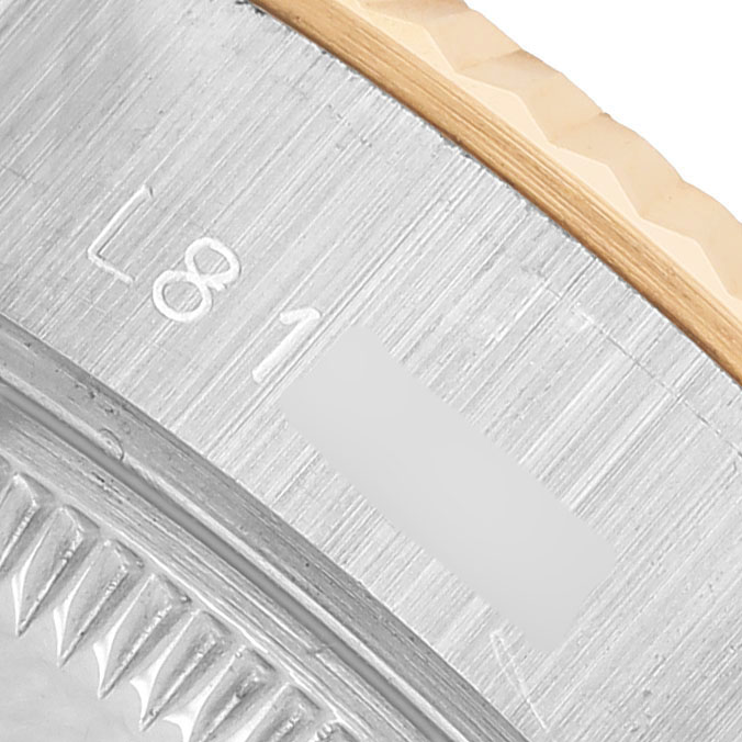 The image shows a close-up angle of the fluted bezel and part of the case of a Rolex Datejust 69173 Women's Steel and Gold (two tone) Champagne Dial watch.