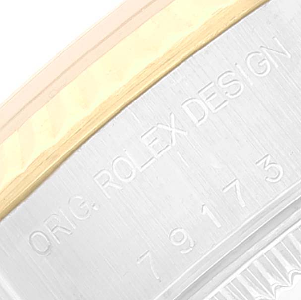 Close-up of the serial number engraving on the side of the Rolex Datejust 79173 Women's Steel and Gold (two tone) White Dial 79173 Women's Steel and Gold (two tone) White Dial watch case.