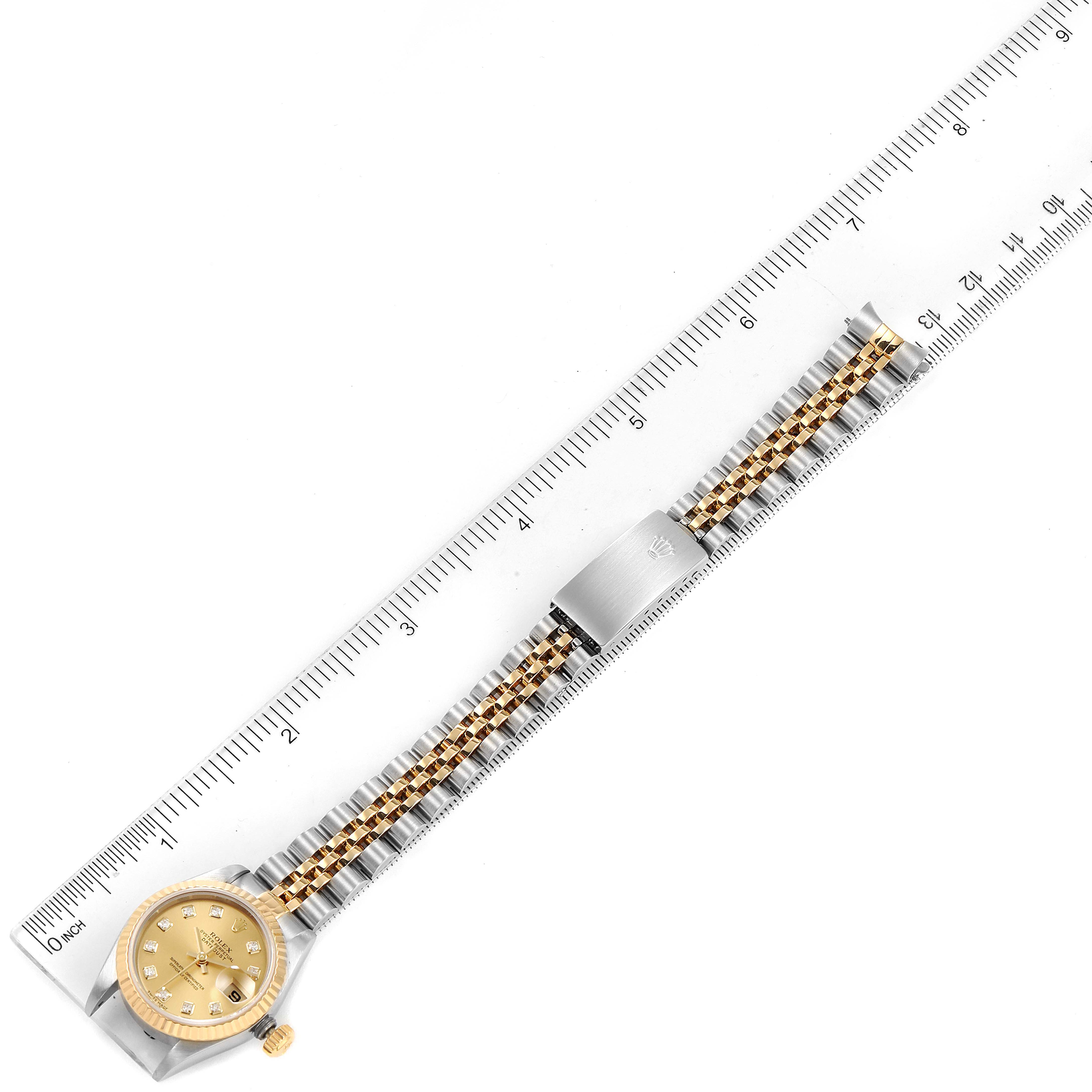 The image shows a Rolex Datejust 69173 Women's Steel and Gold (two tone) Champagne Dial 69173 Women's Steel and Gold (two tone) Champagne Dial watch, displayed at a slight angle with a ruler, showcasing the dial, bezel, and bracelet.