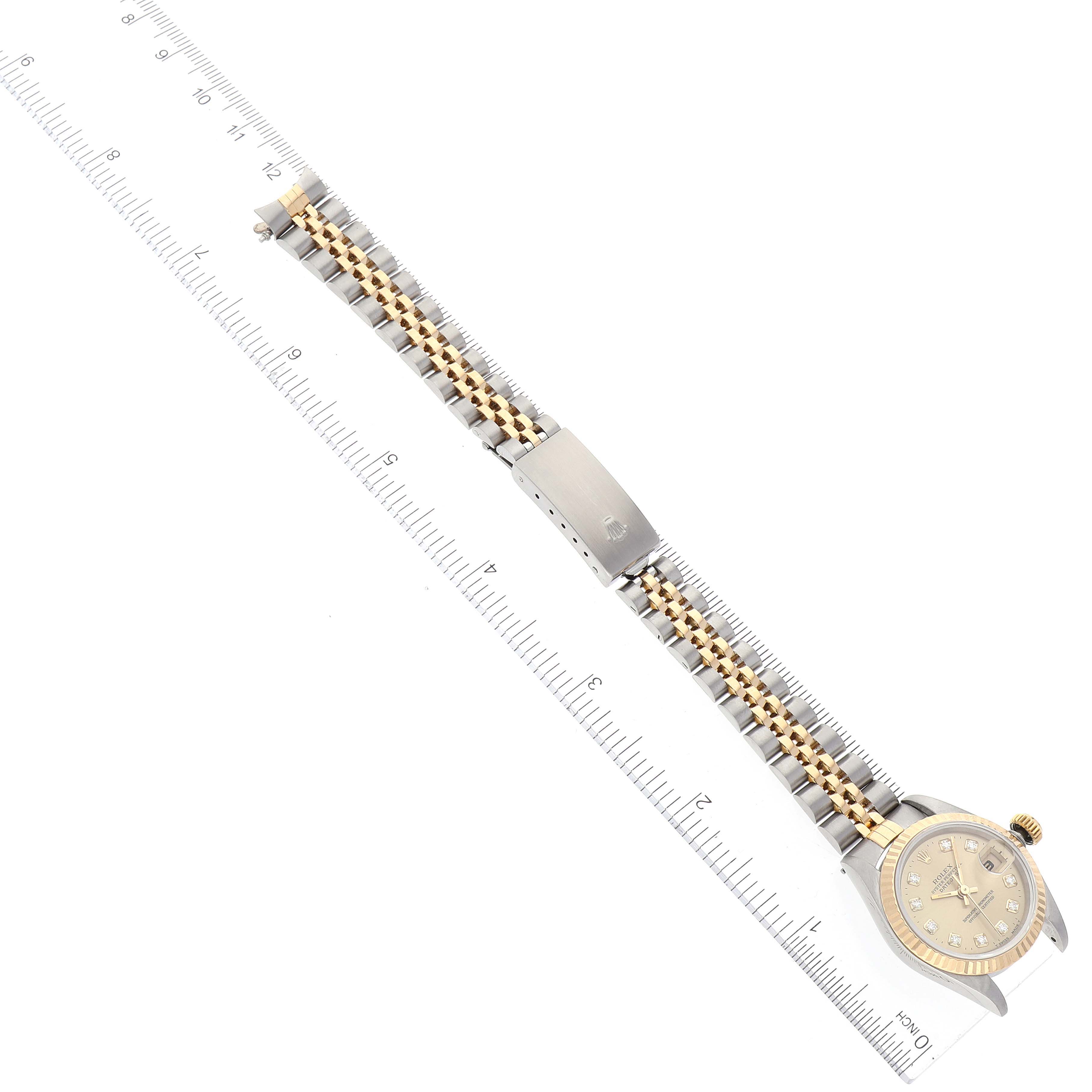 The image shows a Rolex Datejust 69173 Women's Steel and Gold (two tone) Champagne Dial 69173 Women's Steel and Gold (two tone) Champagne Dial watch laid flat with a ruler for scale, displaying the bracelet and face from a top-down angle.