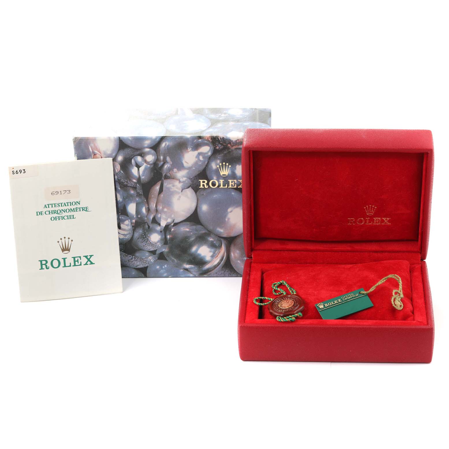 The image shows a Rolex Datejust 69173 Women's Steel and Gold (two tone) Champagne Dial 69173 Women's Steel and Gold (two tone) Champagne Dial model box, a red Rolex watch case, a booklet, and a green tag accessory.