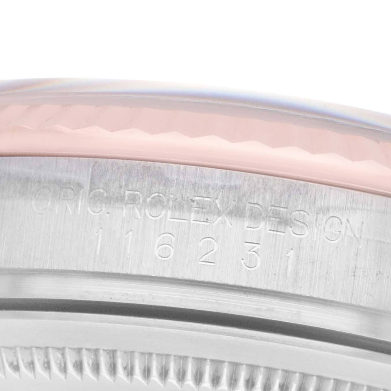 The image shows a close-up of the side of a Rolex Datejust 116231 Men's Steel and Gold (two tone) Silver Dial, focusing on the bezel and engraved serial number.