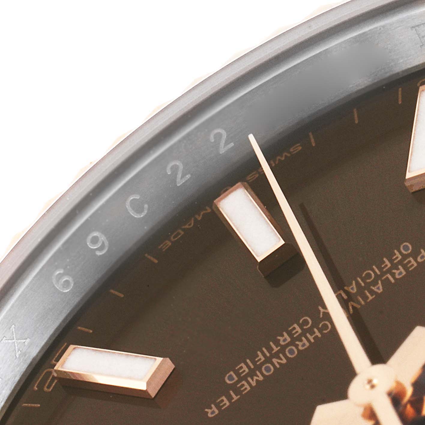 The image shows a close-up of the dial and hands of a Rolex Datejust 41 126331 Men's Steel and Gold (two tone) Brown Dial 126331 Men's Steel and Gold (two tone) Brown Dial, highlighting the markers and text "Swiss Made."