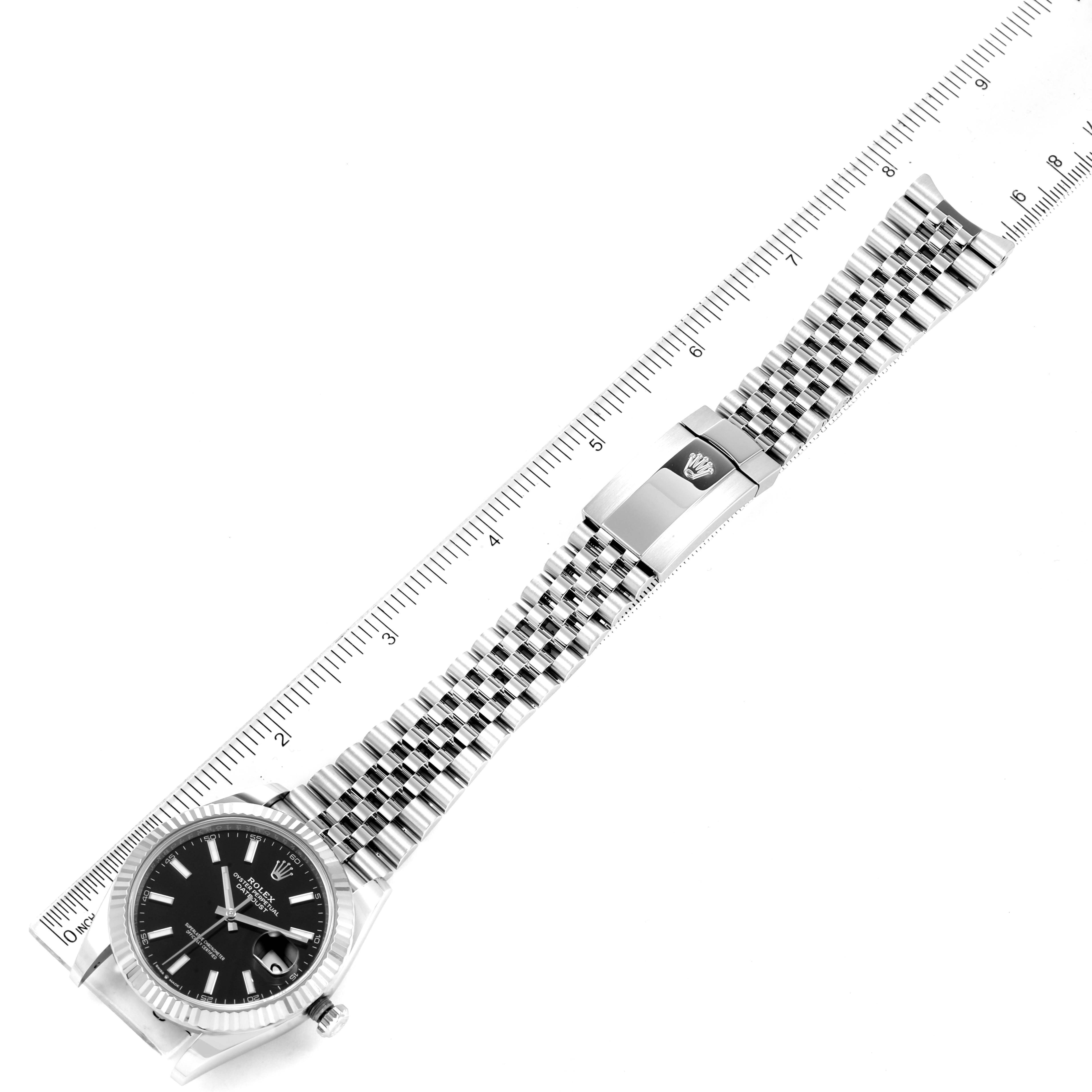 This image shows a top-down view of the Rolex Datejust 41 126334 Men
s Stainless Steel Black Dial 126334 Men
s Stainless Steel Black Dial watch with its bracelet and clasp, along with a ruler for scale.