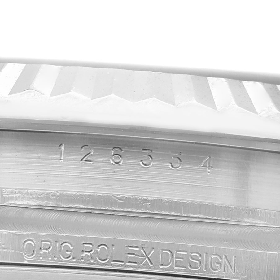 The image shows a close-up of the model number and "ORIG ROLEX DESIGN" engraving on the side of a Rolex Datejust 41 126334 Men's Stainless Steel Blue Dial watch case.
