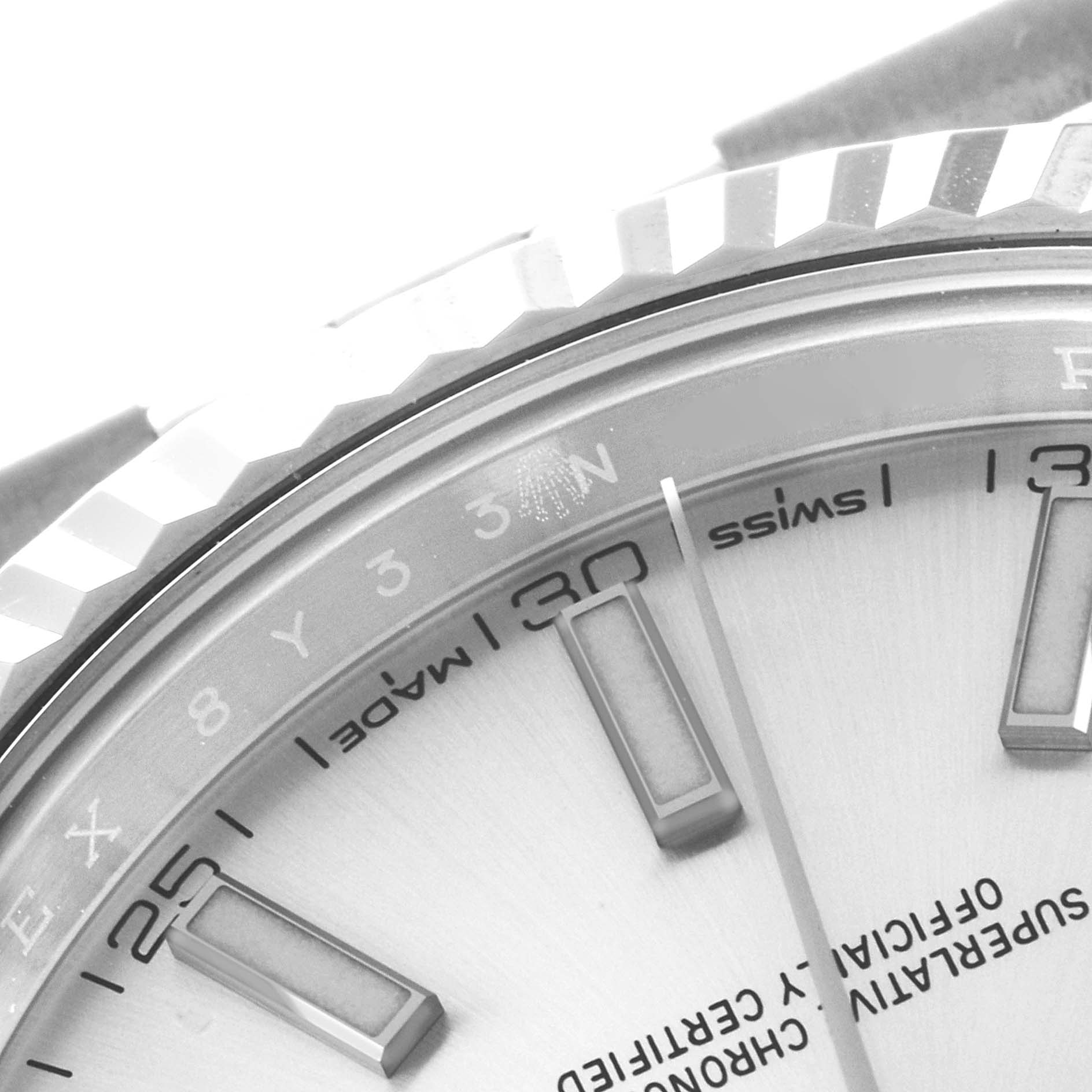 This close-up image shows part of the dial and the fluted bezel of a Rolex Datejust 41 126334 Men's Stainless Steel Silver Dial 126334 Men's Stainless Steel Silver Dial watch.