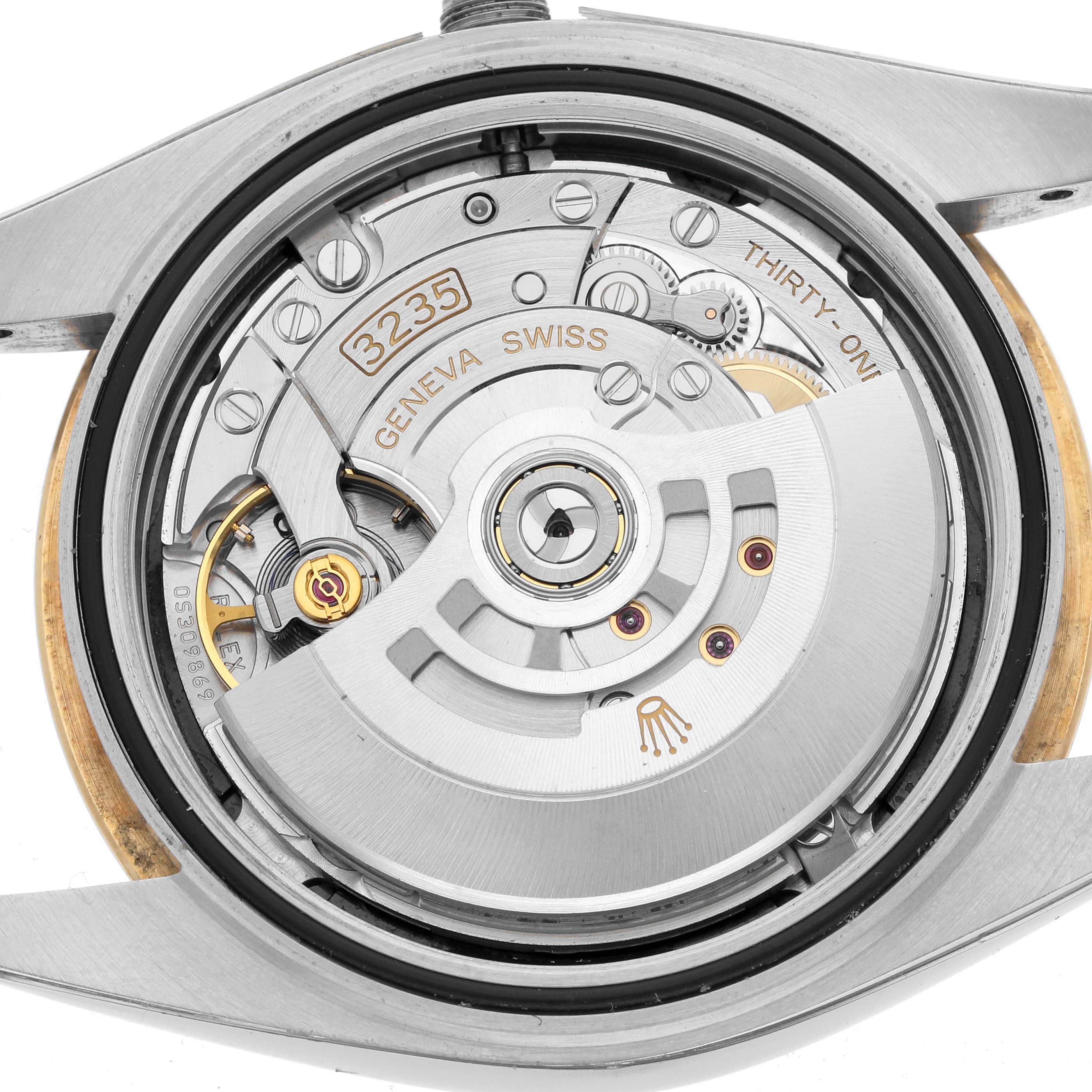 The image shows the Rolex Datejust 41 126333 Men's Steel and Gold (two tone) Black Dial's movement from a back angle, highlighting the rotor and internal mechanics.