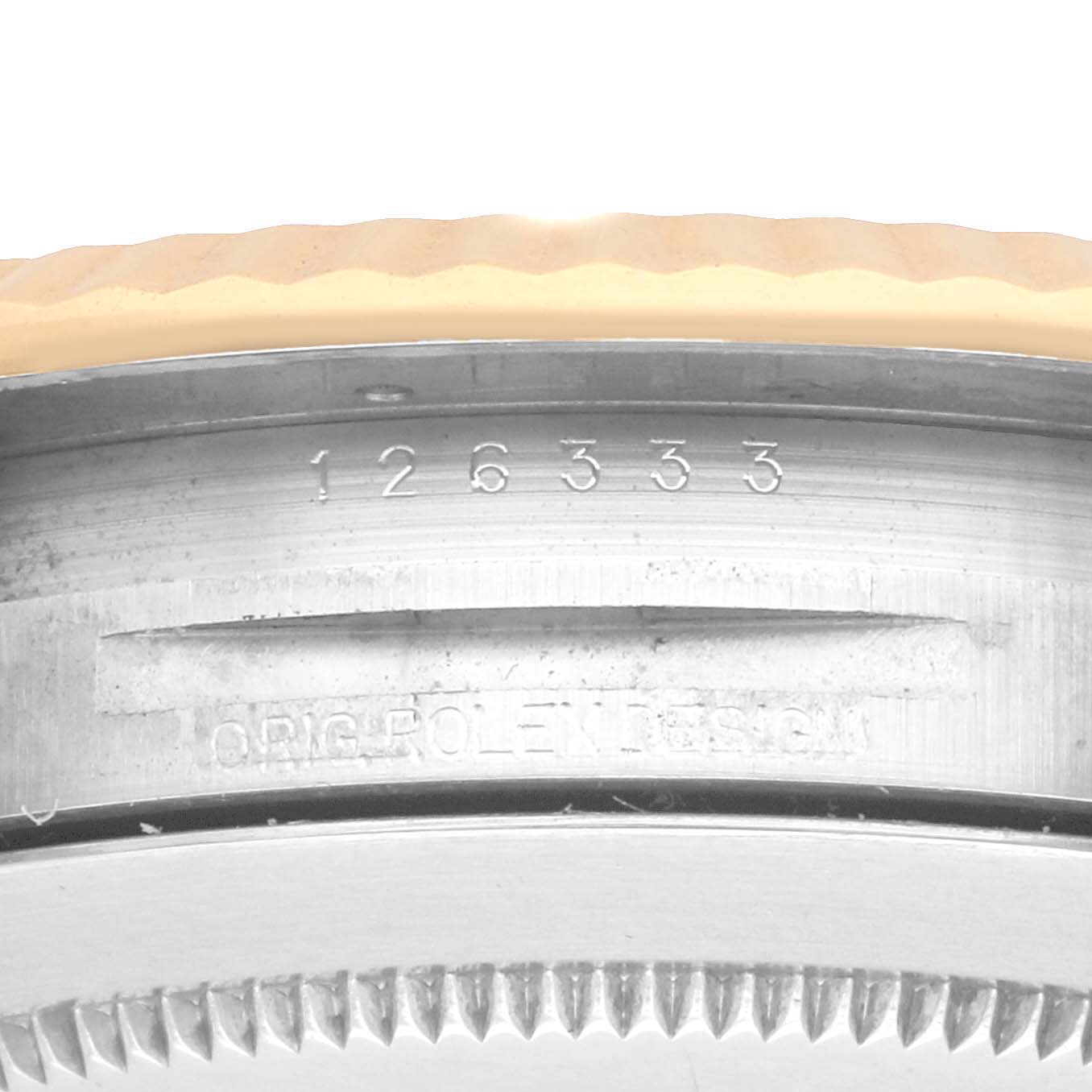 The image shows the side view of a Rolex Datejust 41 126333 Men's Steel and Gold (two tone) Black Dial, featuring the case edge with engraved text and part of the bezel.