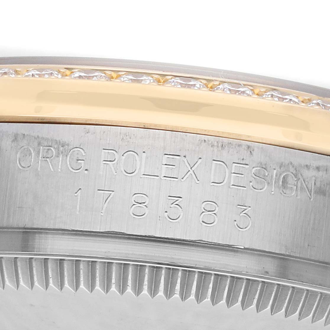 The image shows the side view of a Rolex Mid-Size 178383 Women's Steel and Gold (two tone) Mother of Pearl Dial model, highlighting the bezel and engraved details.
