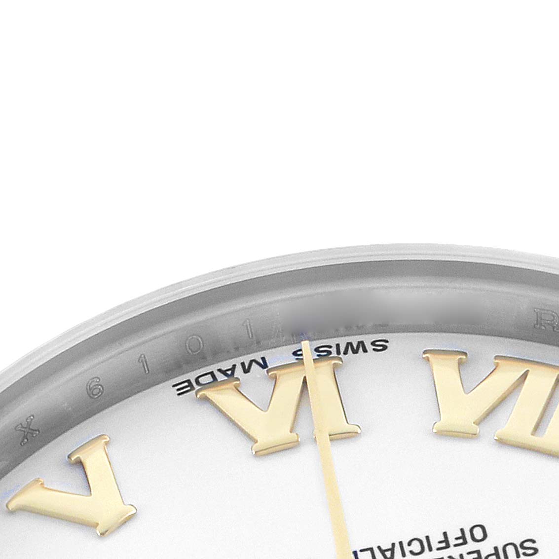This close-up image of a Rolex Mid-Size 178273 Women's Steel and Gold (two tone) White Dial watch shows a portion of the dial and gold Roman numeral markers from an oblique angle.