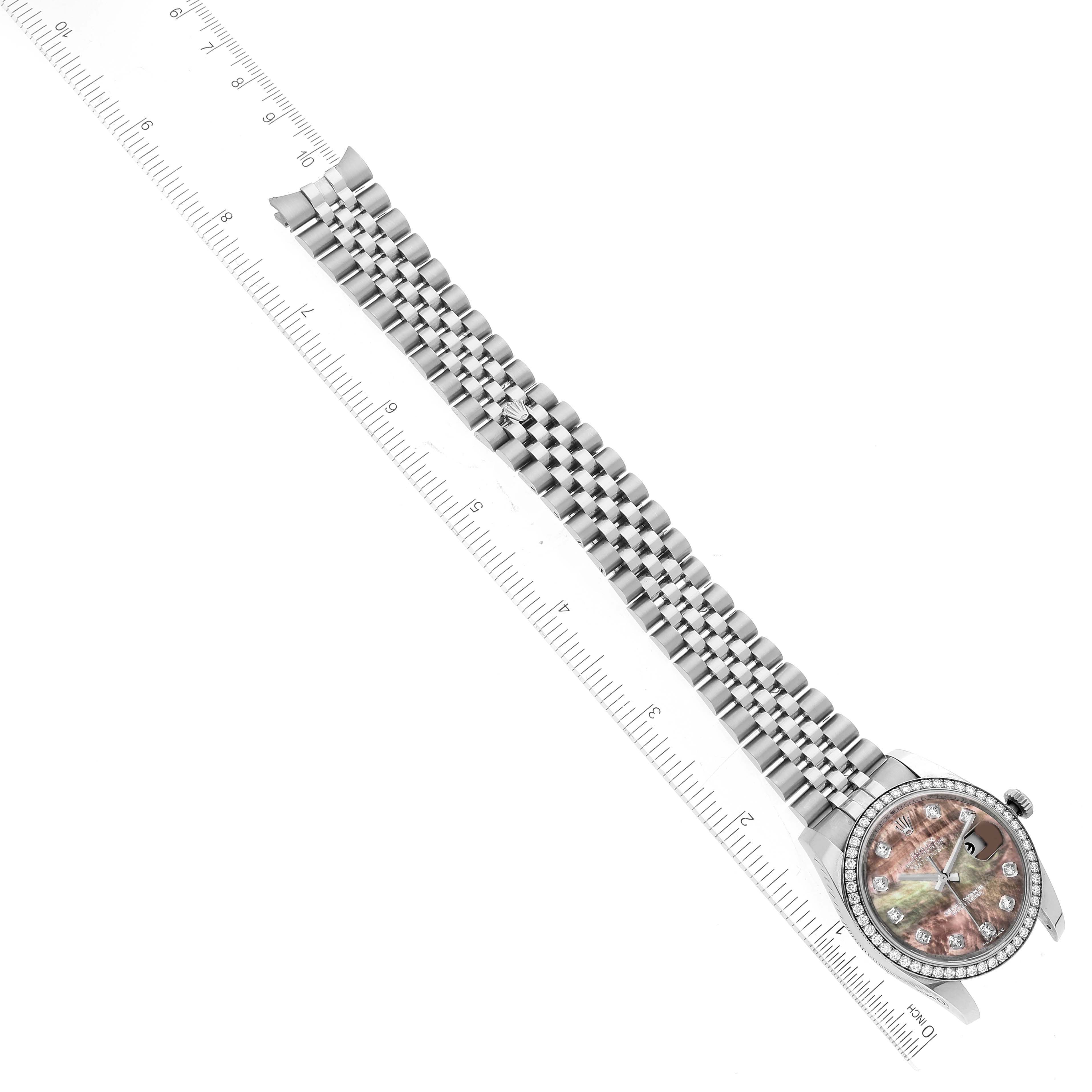 The image shows a top-down view of a Rolex Datejust 116244 Men's Stainless Steel Mother of Pearl Dial 116244 Men's Stainless Steel Mother of Pearl Dial watch, including its full bracelet and face next to a ruler for measurement.