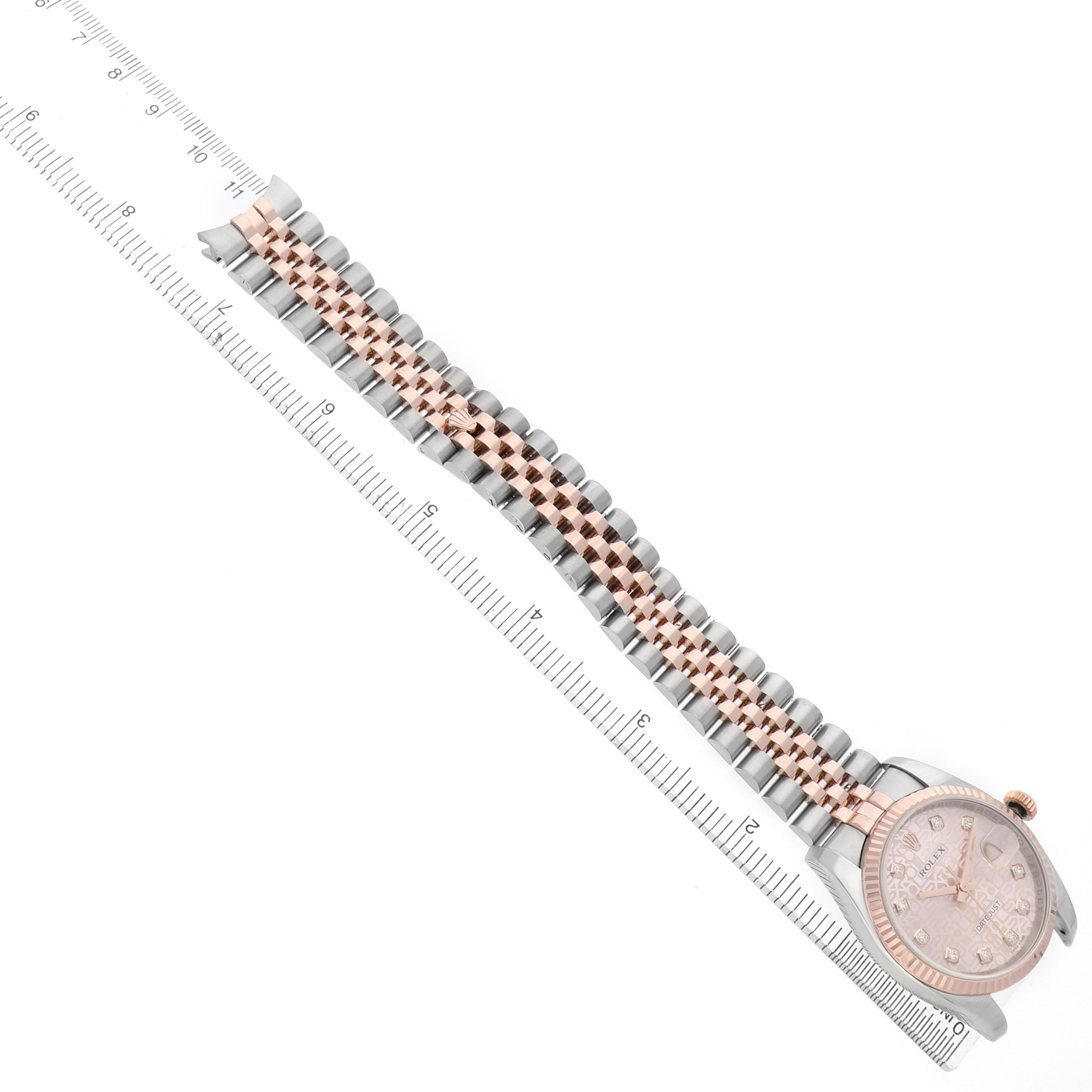The image shows a Rolex Datejust 116231 Men's Steel and Gold (two tone) Pink Dial watch at an angle highlighting its band, face, and a ruler for scale.