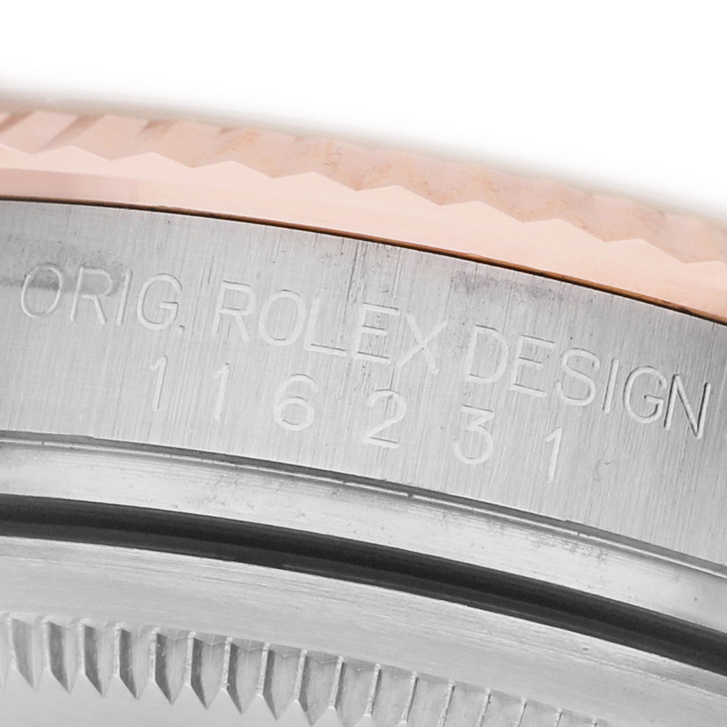 The image shows a close-up of the Rolex Datejust 116231 Men's Steel and Gold (two tone) Pink Dial watch's side, highlighting the engraved model number and fluted bezel.