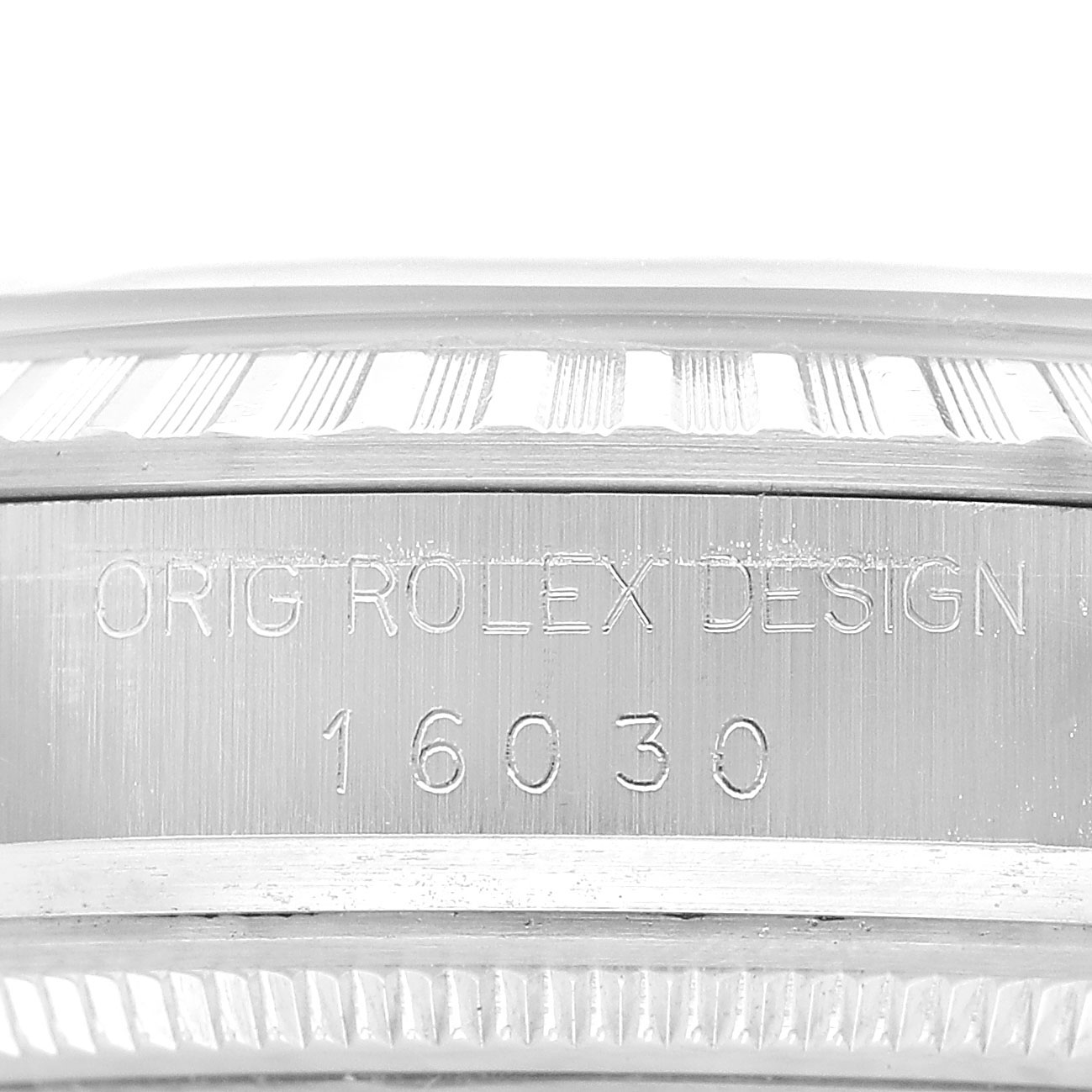 The image shows a close-up of the engraved model number and "ORIG ROLEX DESIGN" on the side of a Rolex Datejust 16030 Men's Stainless Steel Silver Dial bezel.