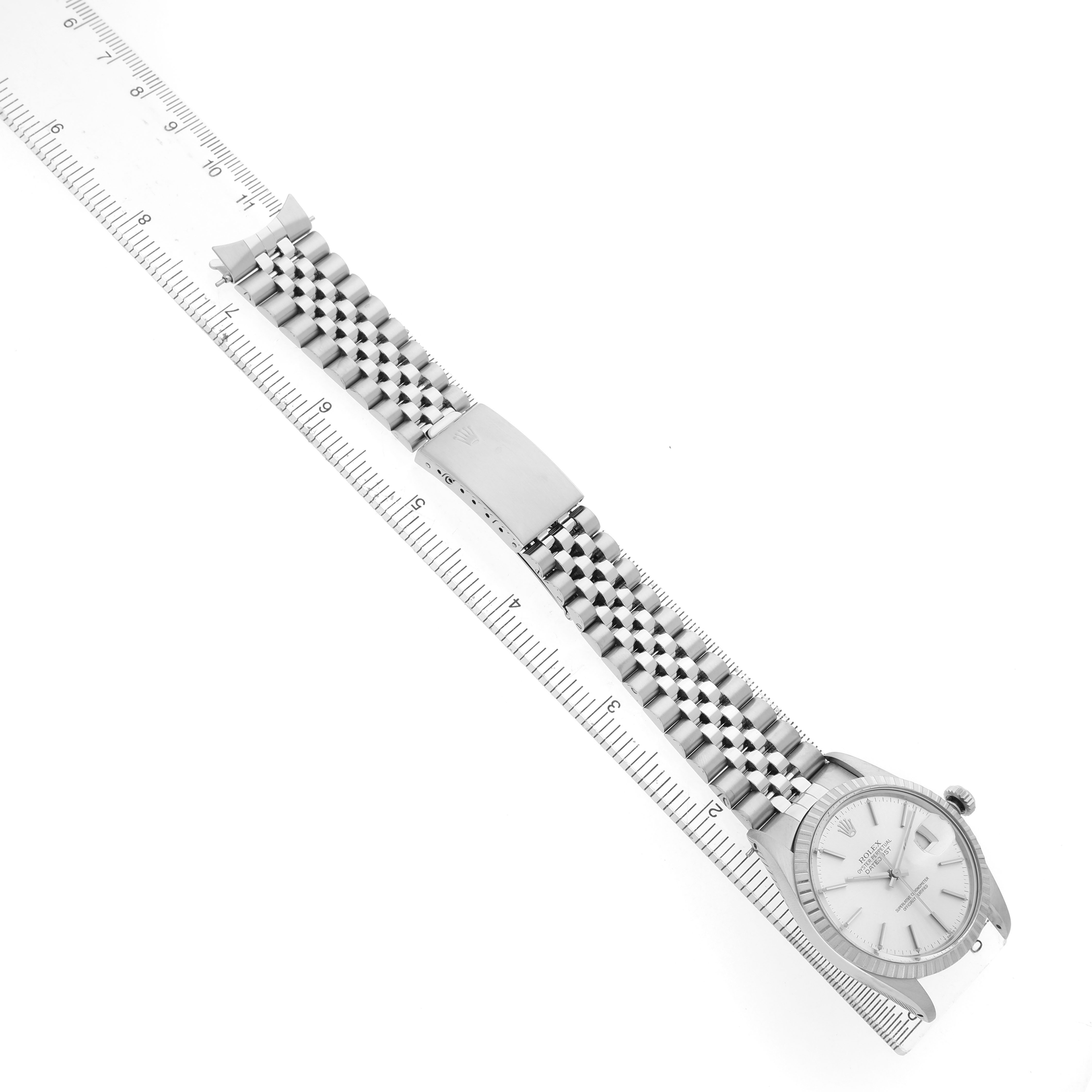 The Rolex Datejust 16030 Men's Stainless Steel Silver Dial watch is shown from a top-down angle, featuring the face, case, and full bracelet alongside a ruler.