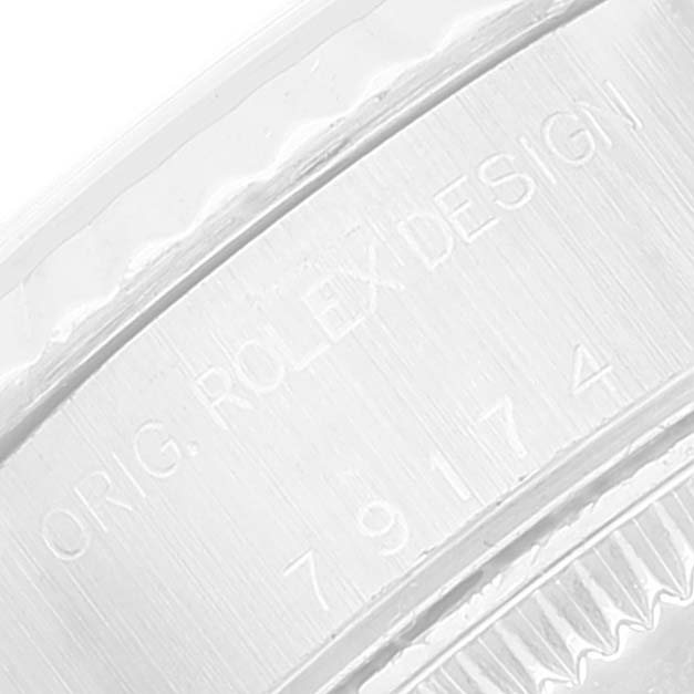 This image shows an extreme close-up of the case side inscription on a Rolex Datejust 79174 Women's Stainless Steel Blue Dial 79174 Women's Stainless Steel Blue Dial watch.