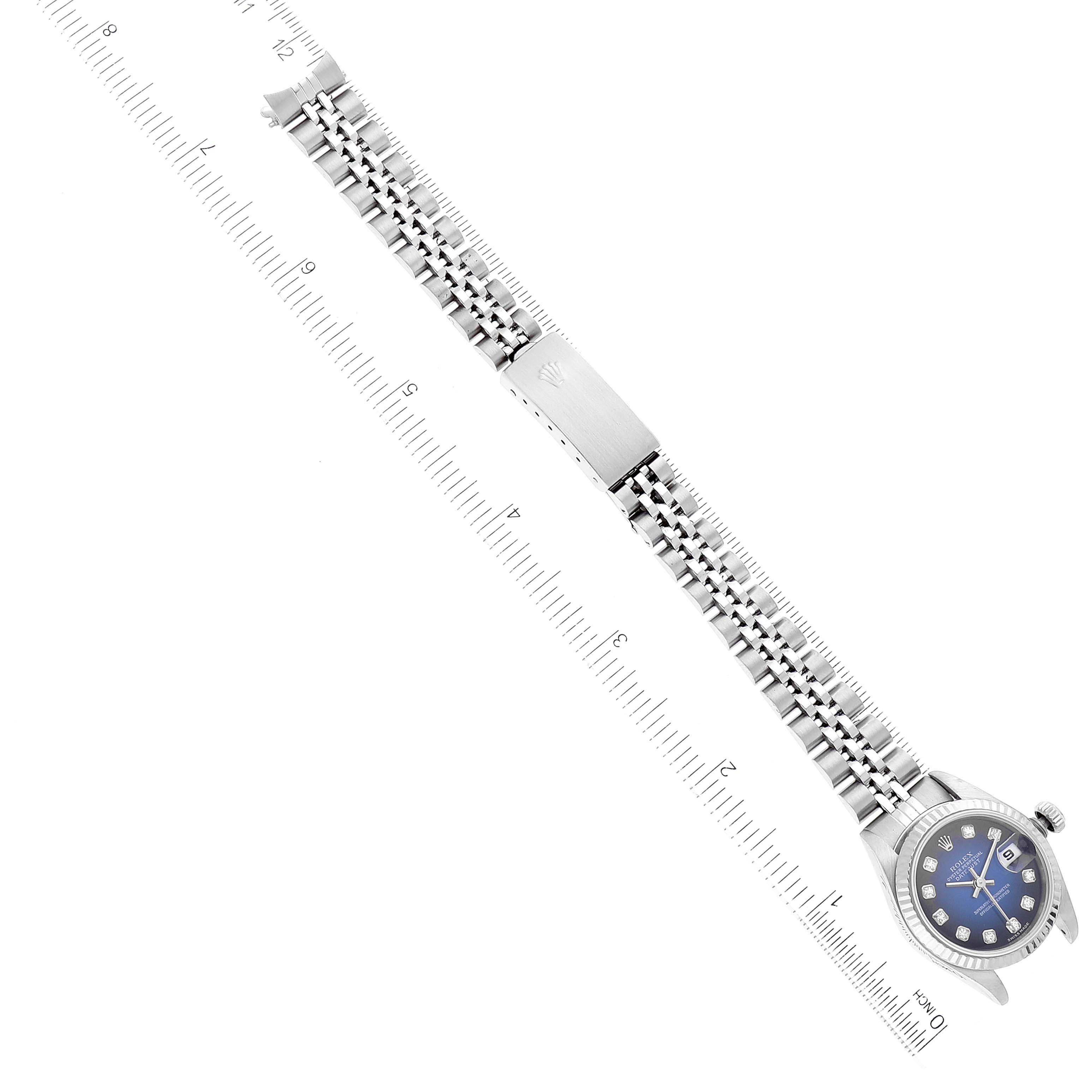 The image shows the Rolex Datejust 79174 Women's Stainless Steel Blue Dial 79174 Women's Stainless Steel Blue Dial watch from a top-down angle, highlighting its face, bracelet, and clasp, with rulers on each side.