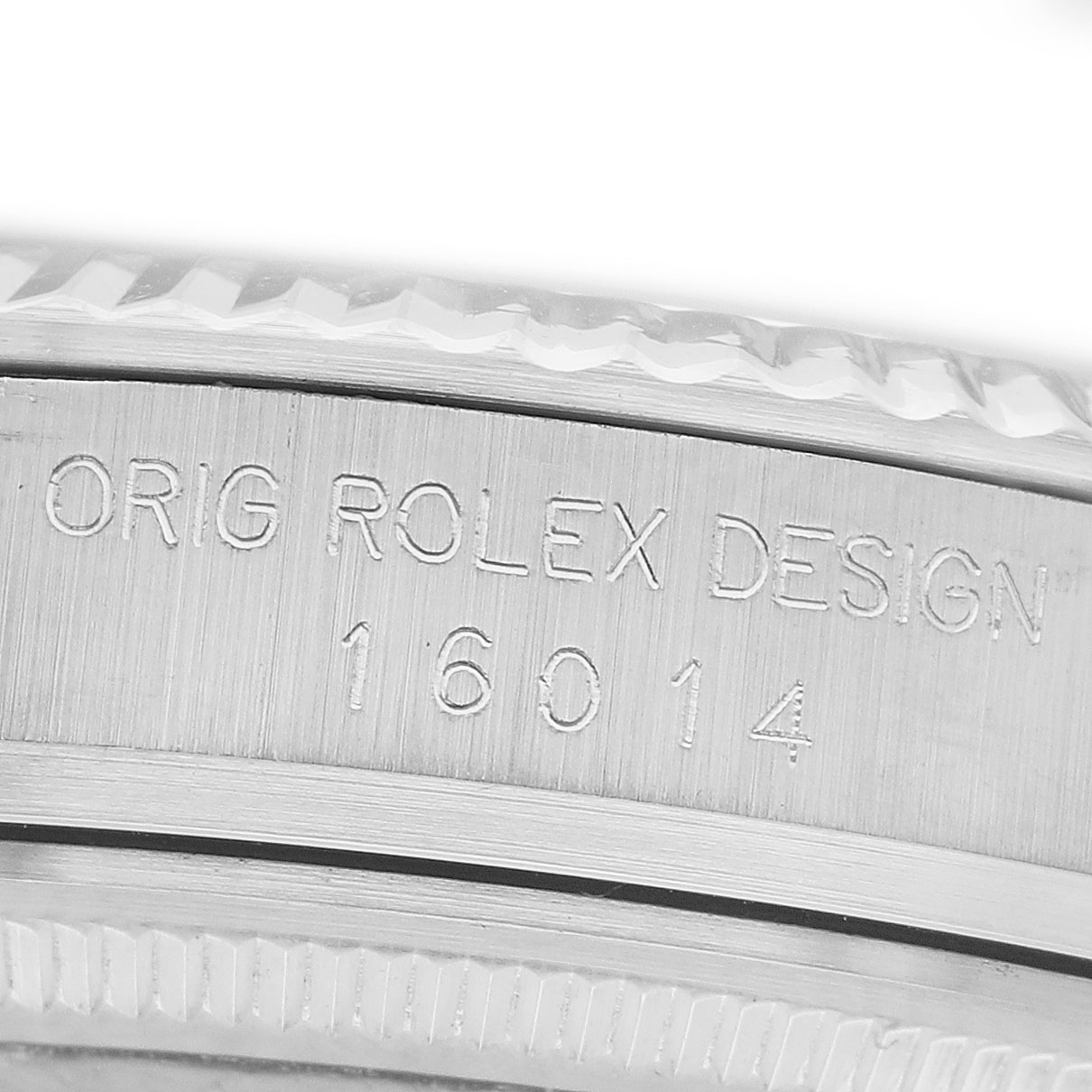 The image shows a close-up of the side of a Rolex Datejust 16014 Men's Stainless Steel Silver Dial watch's case with engraved design and model number.