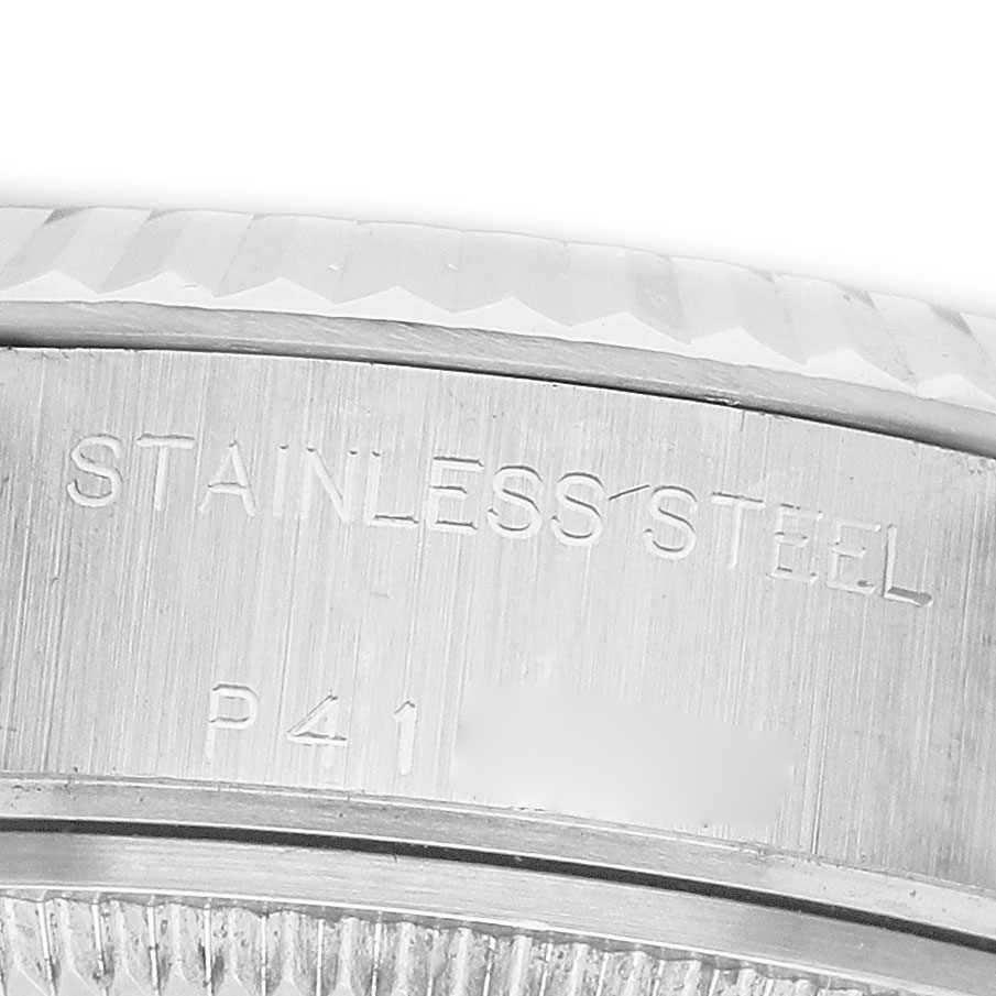 The image shows a close-up of the stainless steel casing on a Rolex Datejust 79174 Women's Stainless Steel Silver Dial watch, highlighting the engraved details.