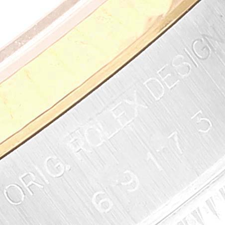 This image shows a close-up of the engraved text on the case back of the Rolex Datejust 69173 Women's Steel and Gold (two tone) Silver Dial 69173 Women's Steel and Gold (two tone) Silver Dial watch.