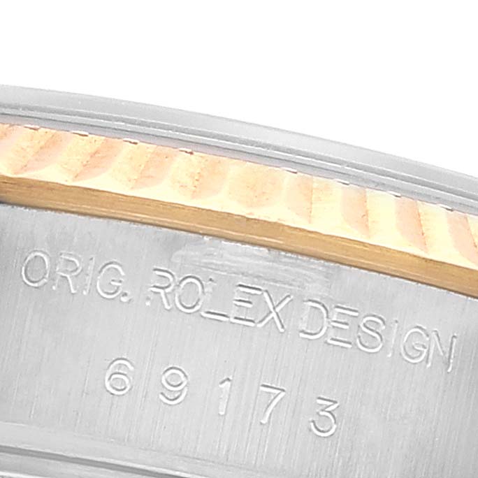 This close-up image shows the case side of a Rolex Datejust 69173 Women's Steel and Gold (two tone) Grey Dial 69173 Women's Steel and Gold (two tone) Grey Dial watch with model number 69173 engraved.