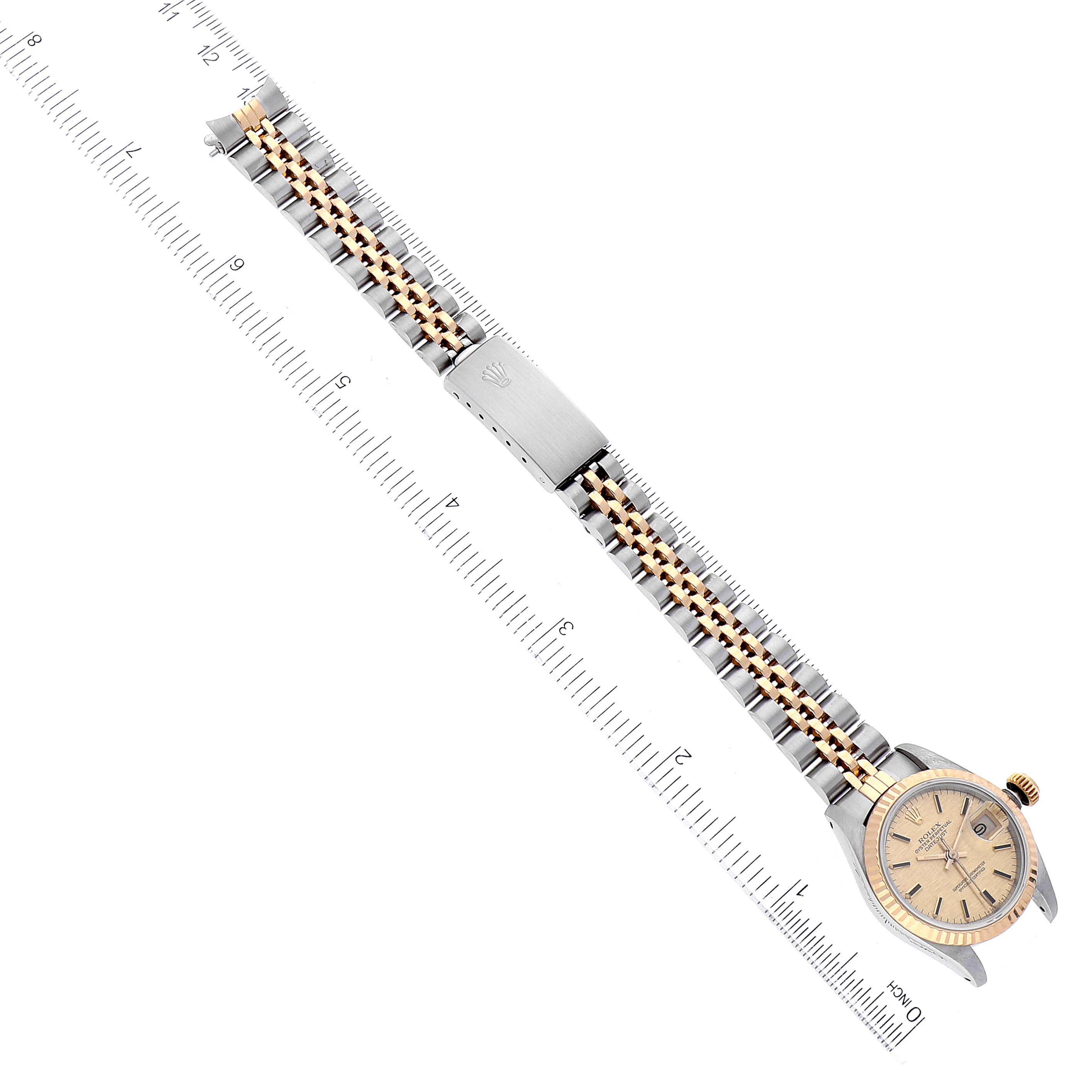 The image shows a Rolex Datejust 69173 Women's Steel and Gold (two tone) Champagne Dial 69173 Women's Steel and Gold (two tone) Champagne Dial watch laid flat with a view of the front face, bracelet, and clasp, positioned along a ruler.