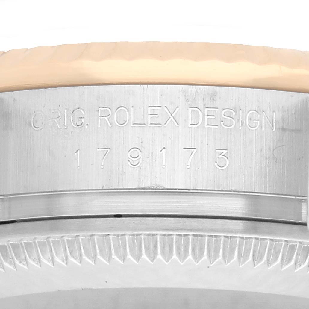 The image shows a close-up of the side case and edge of the bezel of a Rolex Datejust 179173 Women's Steel and Gold (two tone) Silver Dial, highlighting the engraved model number.