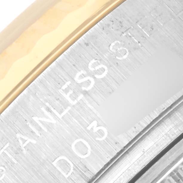 The image shows a close-up of the side of a Rolex Datejust 179173 Women's Steel and Gold (two tone) White Dial 179173 Women's Steel and Gold (two tone) White Dial case with "STAINLESS STEEL" engraved on it.