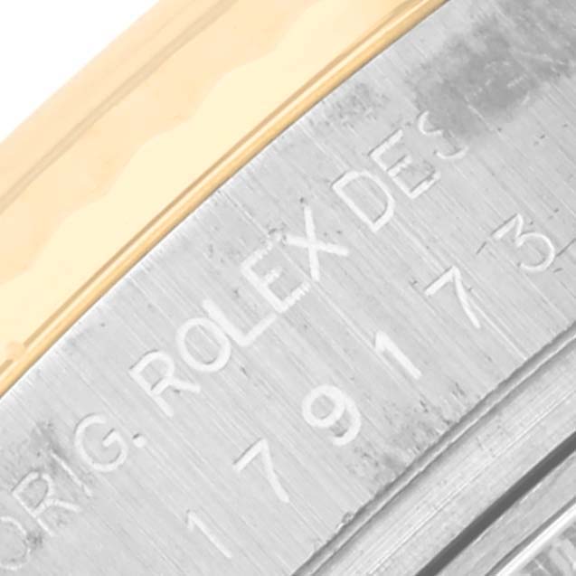 The image shows a close-up of the bezel and engraved details of a Rolex Datejust 179173 Women's Steel and Gold (two tone) White Dial 179173 Women's Steel and Gold (two tone) White Dial watch.