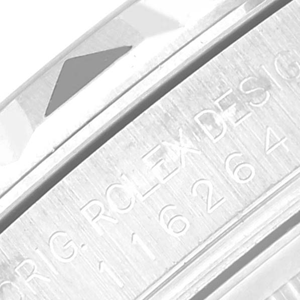 The image shows a close-up of the engraved edge and part of the bezel of a Rolex Turn-o-Graph 116264 Men's Stainless Steel Blue Dial watch.