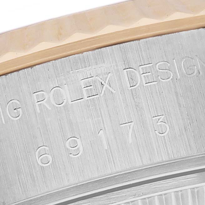The image shows a close-up of the Rolex Datejust 69173 Women's Steel and Gold (two tone) White Dial 69173 Women's Steel and Gold (two tone) White Dial model's engraved case with the brand name and design number visible.