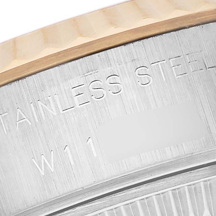 The image shows a close-up of the stainless steel bezel edge of a Rolex Datejust 69173 Women's Steel and Gold (two tone) White Dial 69173 Women's Steel and Gold (two tone) White Dial watch, highlighting engraved text.