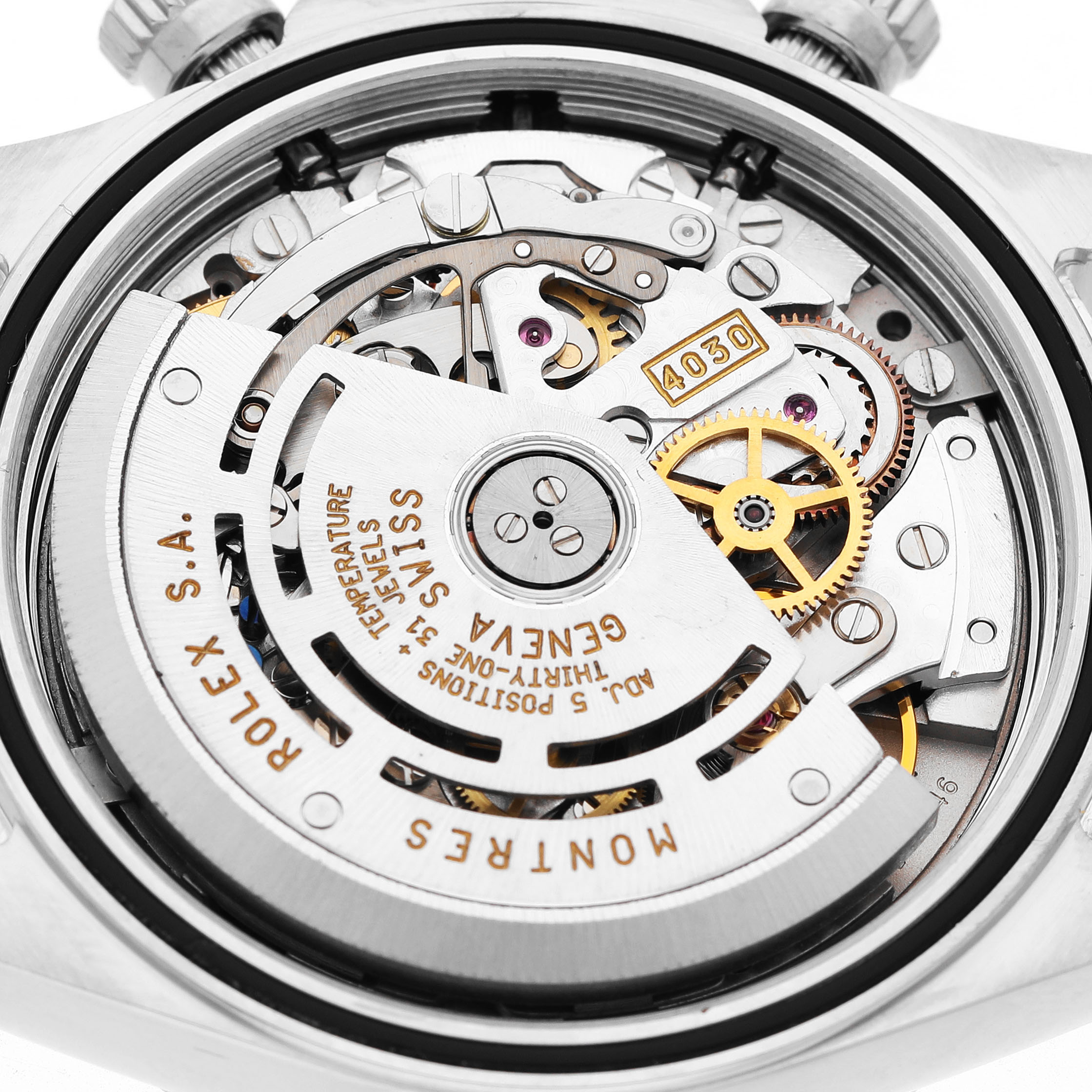 The image shows a detailed close-up of the movement inside the Rolex Daytona 16520 Men's Stainless Steel Black Dial watch.