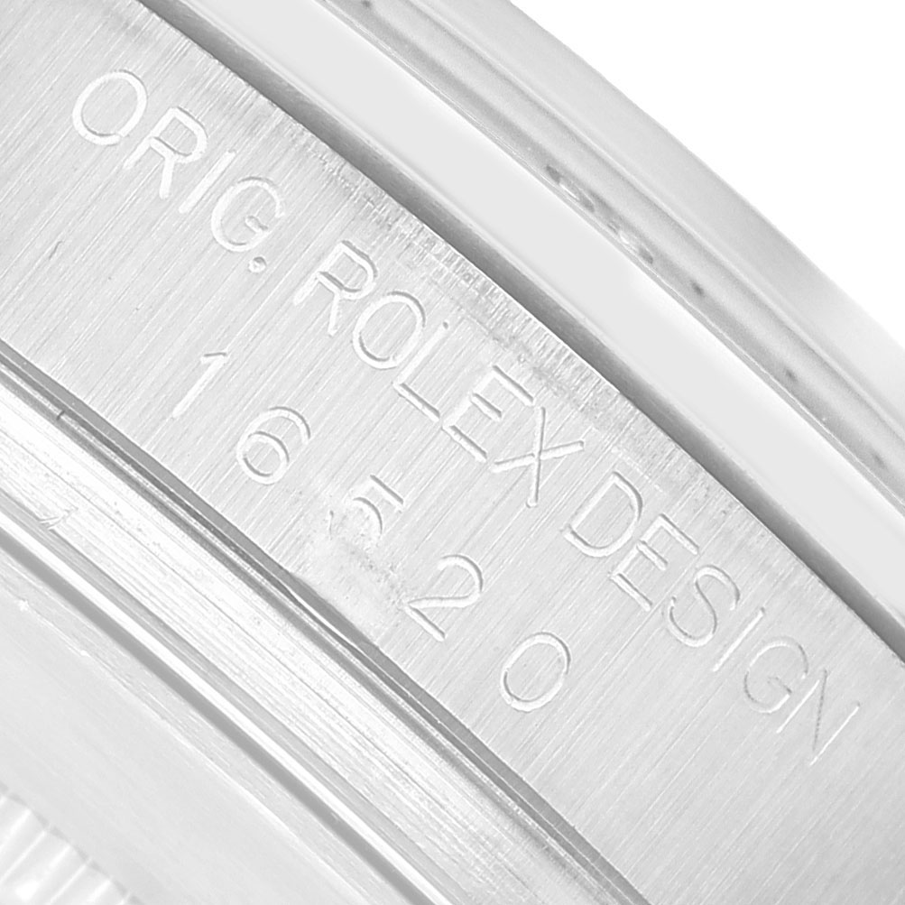 The close-up image shows the engraved side of the case from a Rolex Daytona 16520 Men's Stainless Steel Black Dial with the model number "16520."