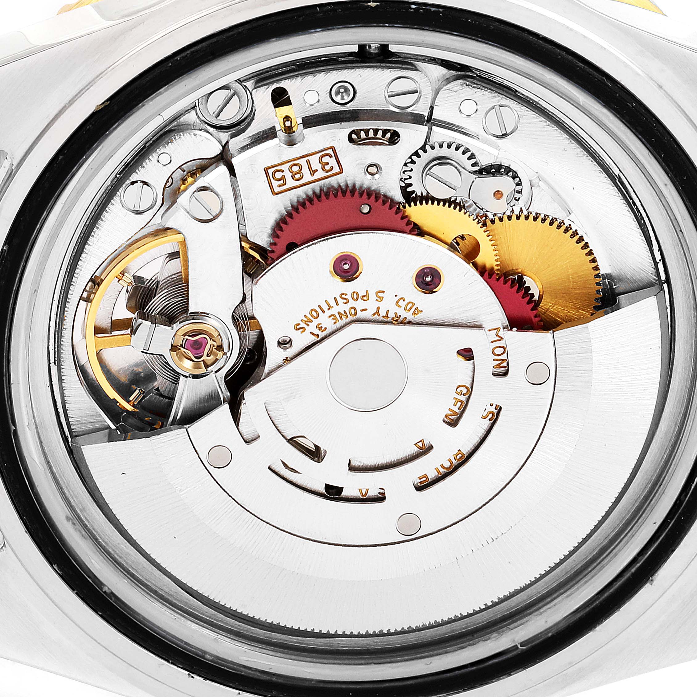 This image shows the movement of a Rolex GMT-Master 16713 Men's Steel and Gold (two tone) Champagne Dial 16713 Men's Steel and Gold (two tone) Champagne Dial watch from an aerial view, highlighting the gears and inner mechanisms.