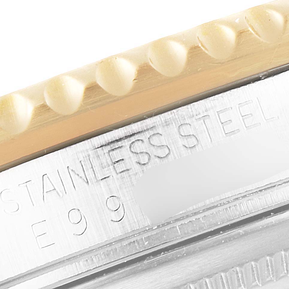 Close-up view of the bezel and case of the Rolex GMT-Master 16713 Men's Steel and Gold (two tone) Champagne Dial 16713 Men's Steel and Gold (two tone) Champagne Dial showing the stainless steel engraving.