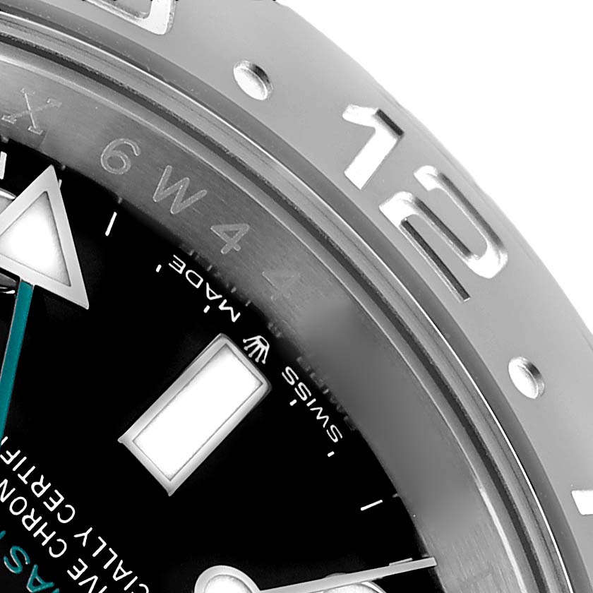 The image shows a close-up of the Rolex GMT-Master 126710 Men's Stainless Steel Black Dial dial and part of the bezel, highlighting the 12 o'clock marker and triangle hand.