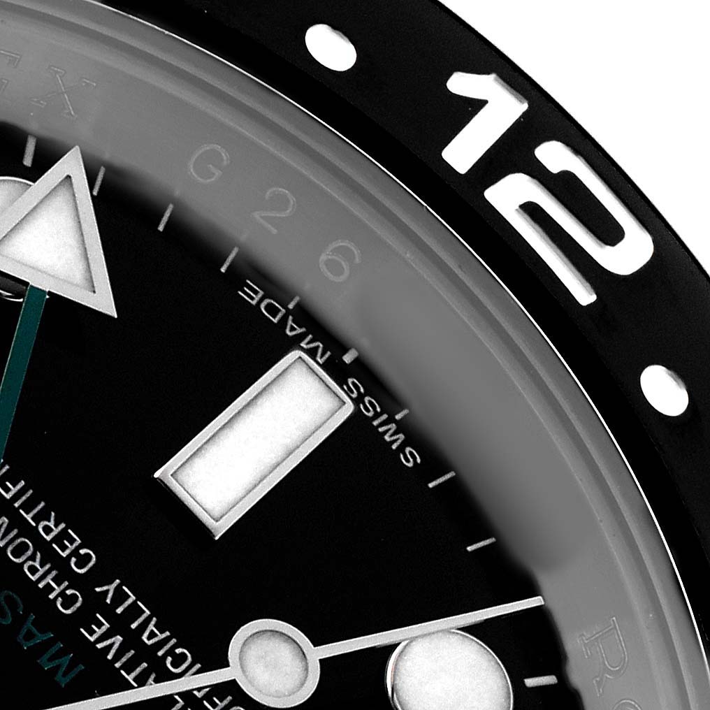 The image shows a close-up of the Rolex GMT-Master 116710LN Men's Stainless Steel Black Dial watch, highlighting the bezel, part of the dial, and hands.