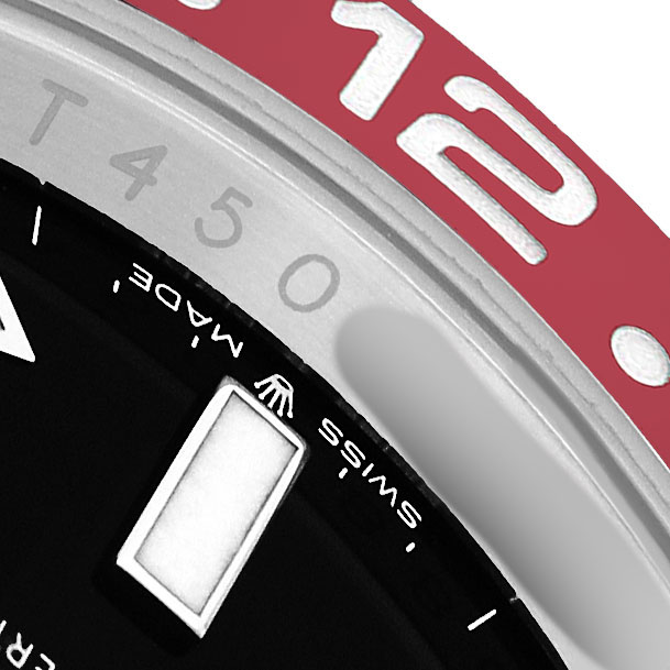 The image shows a close-up of the GMT-Master's bezel, dial edge, and part of the 24-hour markings in red and silver.