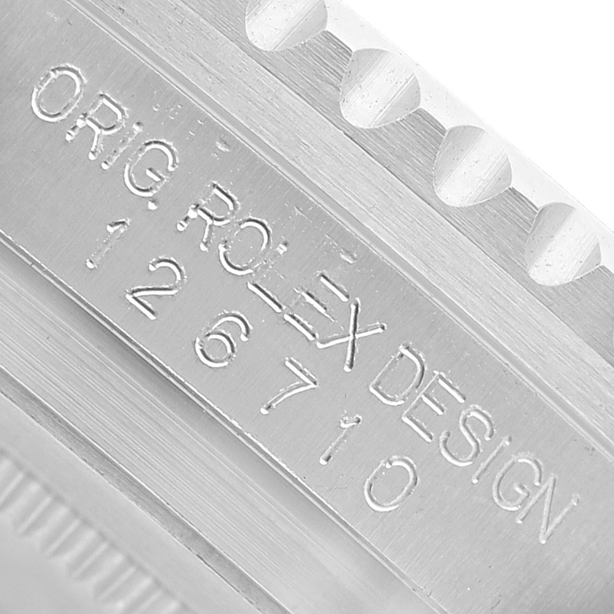The image shows a close-up of the Rolex GMT-Master 126710BLRO Men's Stainless Steel Black Dial model’s case side, focusing on the engraved "ORIG ROLEX DESIGN 126710".