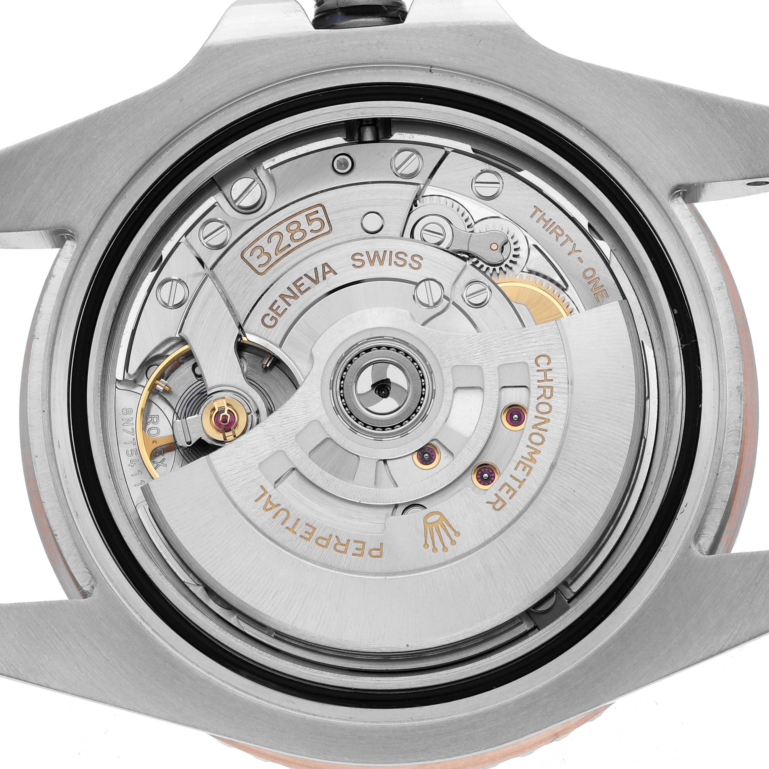 The image shows the back view of a Rolex GMT-Master 126711 Men
s Steel and Gold (two tone) Black Dial watch, focusing on its intricate movement and components.